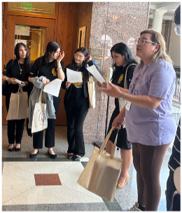 Students listen to a discussion leader in a hallway at the Texas Capitol