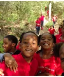a joyful group of children on a hike in a forested area