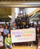 diverse group holding a banner reading People, Parks, and Power
