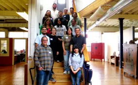 Local partners pose on the stairs at Prevention Institute's Oakland HQ
