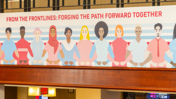 Illustrated mural of diverse people standing shoulder to shoulder beneath text reading “From the frontlines: forging the path forward together”