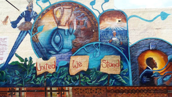a color mural reading United We Stand