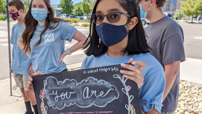 A woman holding a sign